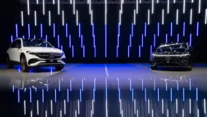 Astera Titan Tubes provide a spectacular backdrop of hundreds of floating white and blue lines behind a pair of cars being showcased
